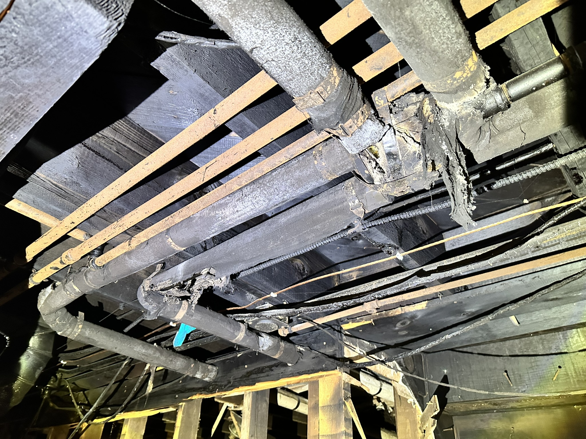 Asbestos containing pipe insulation damaged after a fire