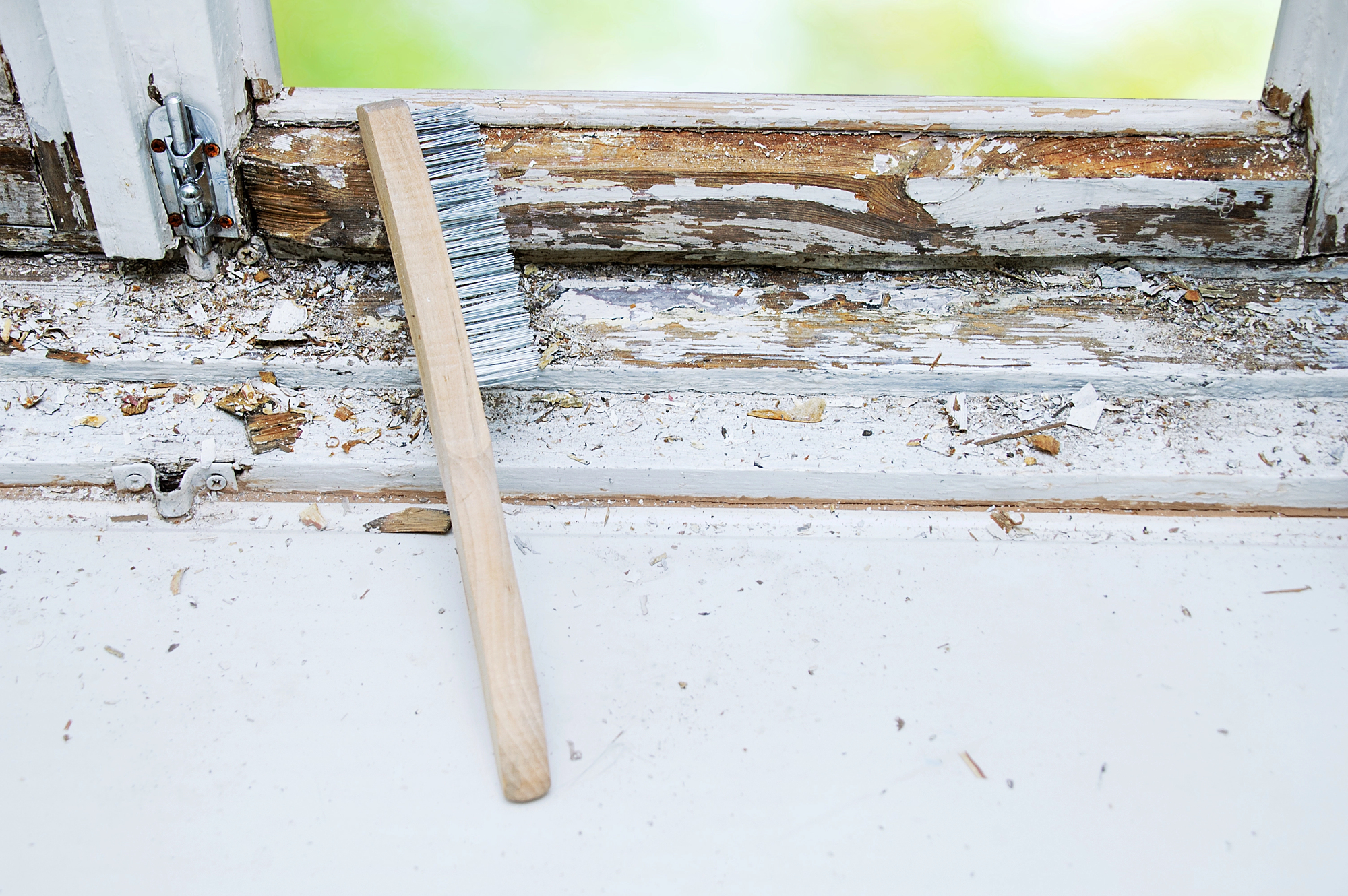 *Photo taken before any lead abatement services were performed by Umbrella Environmental. Without proper containment in place a wire brush should never be used on lead based paint.